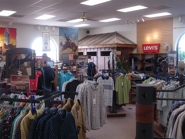 Men's shirts and jeans on racks beneath a Levi's sign