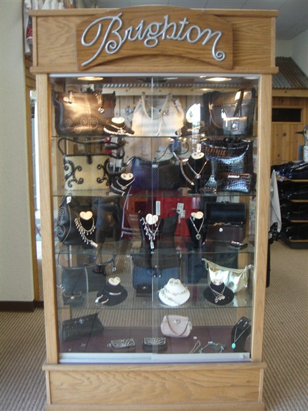 Lit Brighton display case of handbags, belts and jewelry