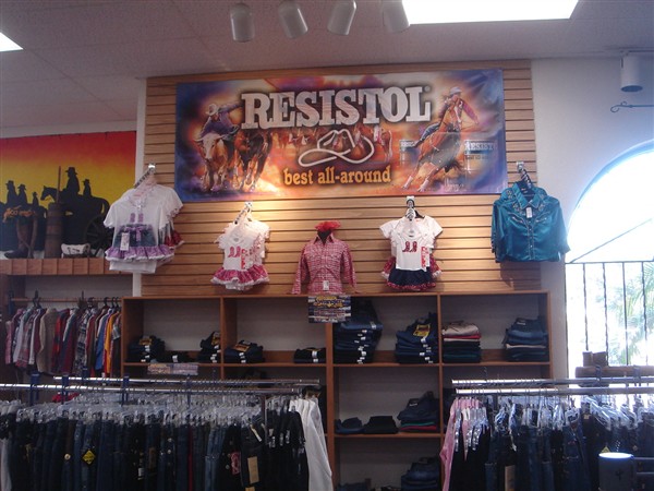 Children's western outfits displayed under a Resistol banner