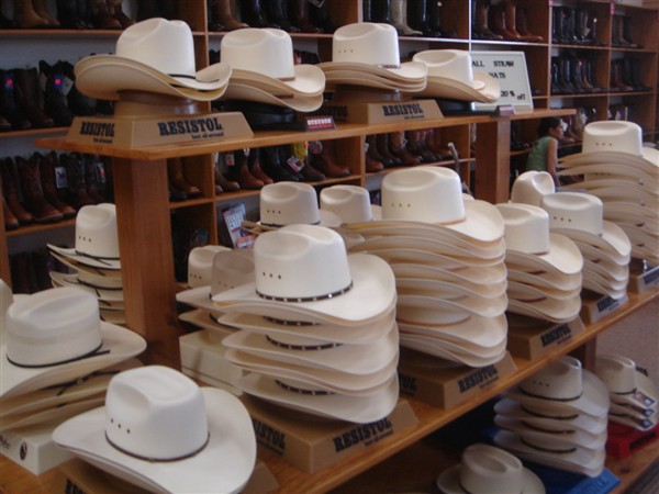 Stacks of straw cowboy hats on Resistol display tables